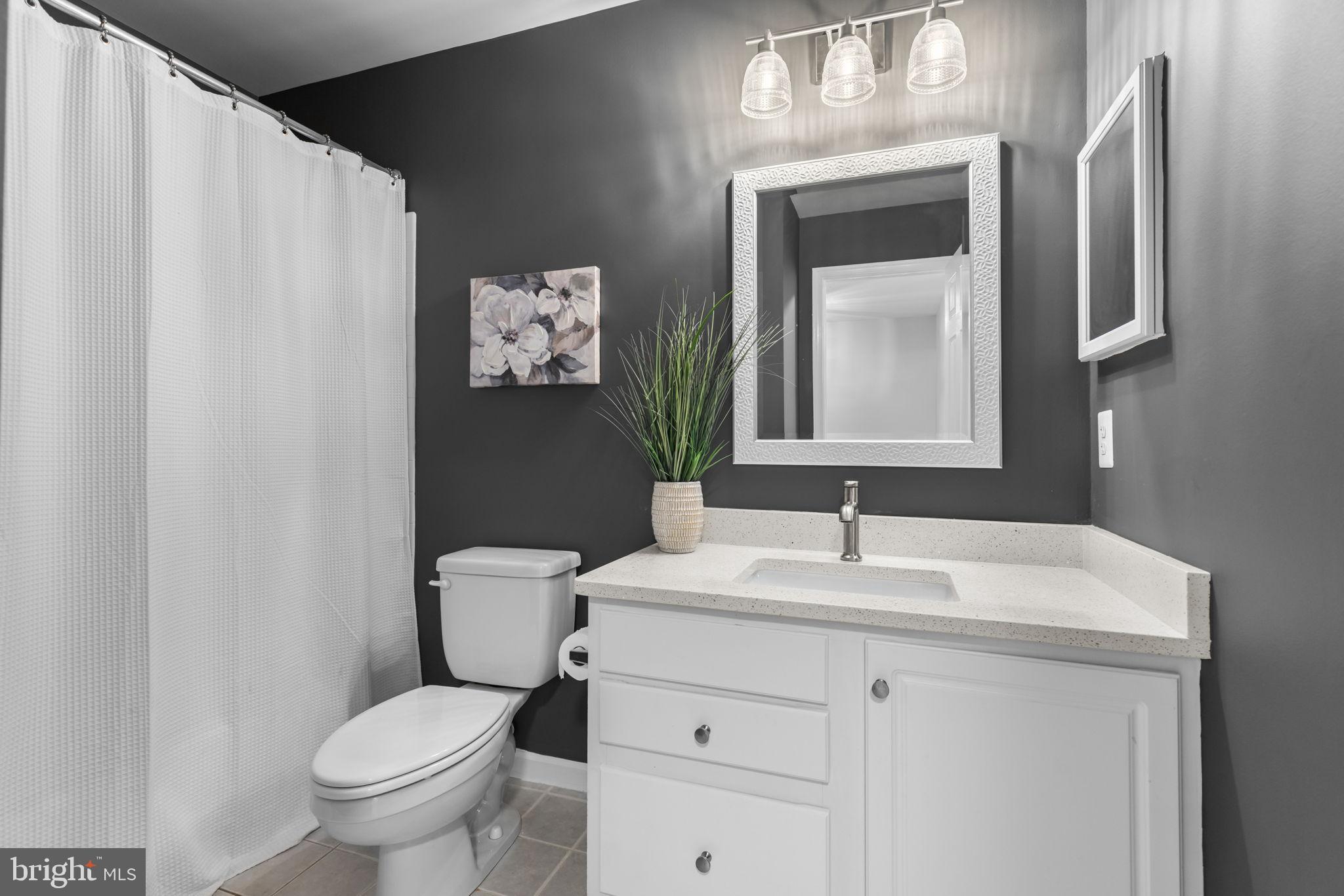 6311 Burgundy Leaf Lane Alexandria, VA 22312 - Photo 26 of 33 a bathroom with a toilet sink and mirror