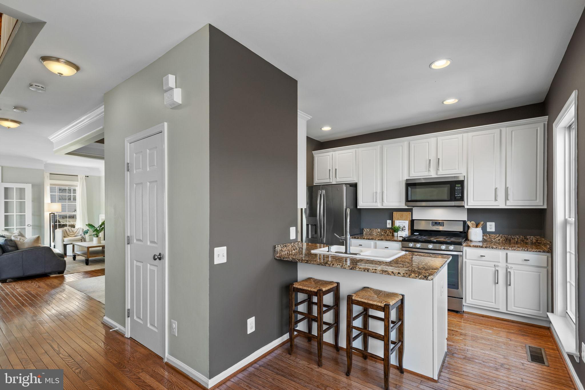 6311 Burgundy Leaf Lane Alexandria, VA 22312 - Photo 8 of 33 a kitchen with stainless steel appliances granite countertop a stove refrigerator sink and cabinets