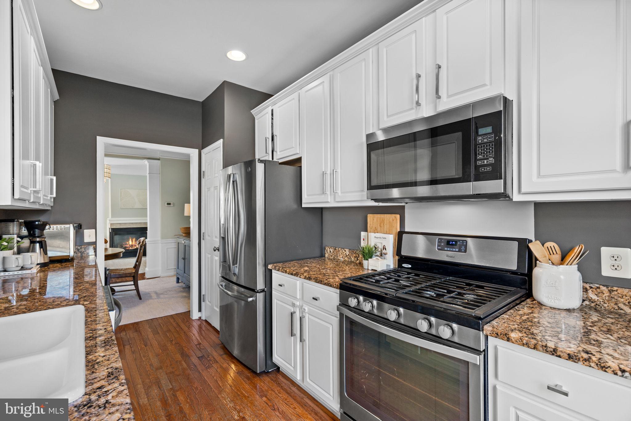 6311 Burgundy Leaf Lane Alexandria, VA 22312 - Photo 9 of 33 a kitchen with stainless steel appliances granite countertop a stove a refrigerator and a microwave