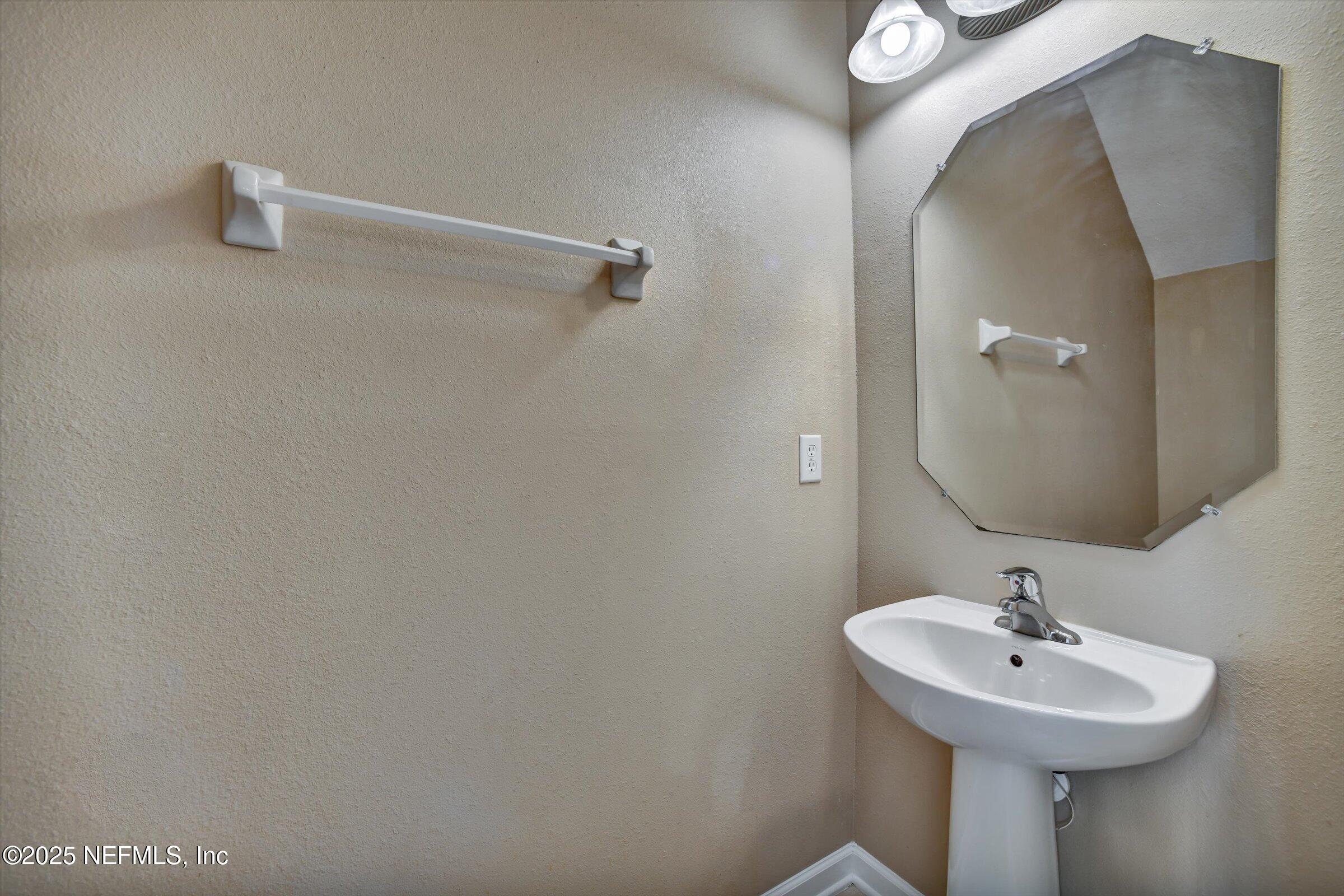 480 Cabernet Place St. Augustine, FL 32084 - Photo 16 of 37 a bathroom with a sink and mirror
