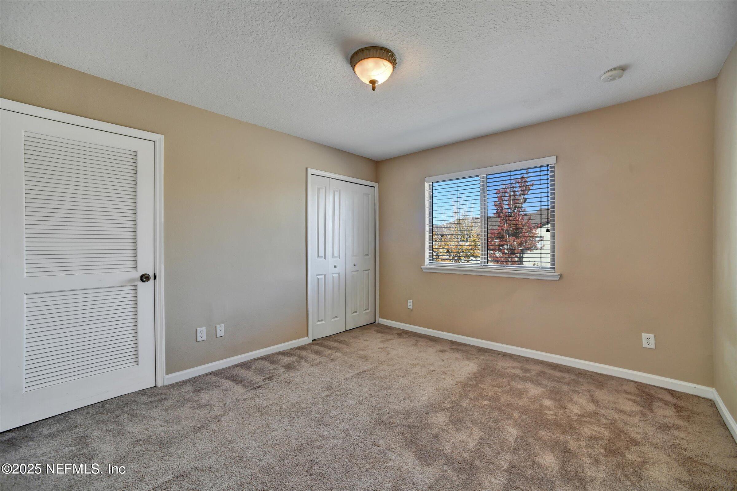 480 Cabernet Place St. Augustine, FL 32084 - Photo 22 of 37 a view of an empty room with a window