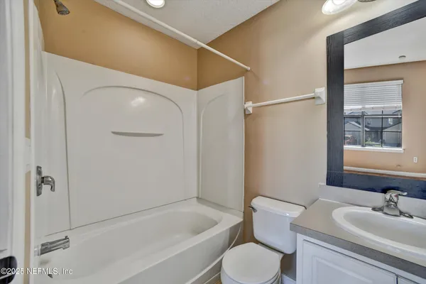 a bathroom with a sink vanity and mirror
