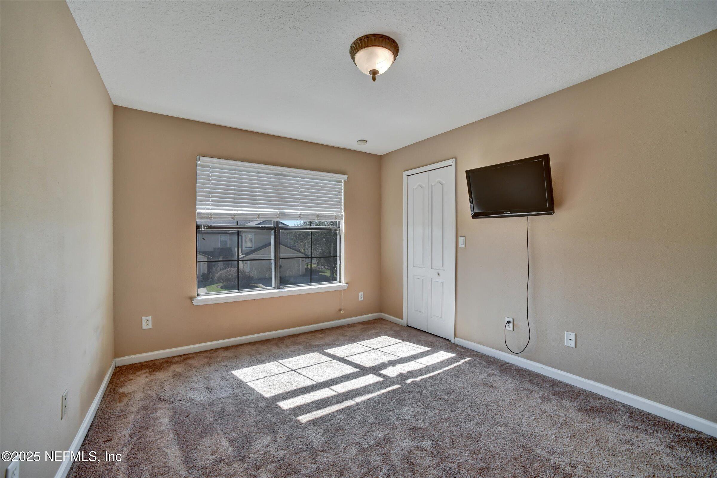 480 Cabernet Place St. Augustine, FL 32084 - Photo 33 of 37 a view of workspace with window and a flat screen tv