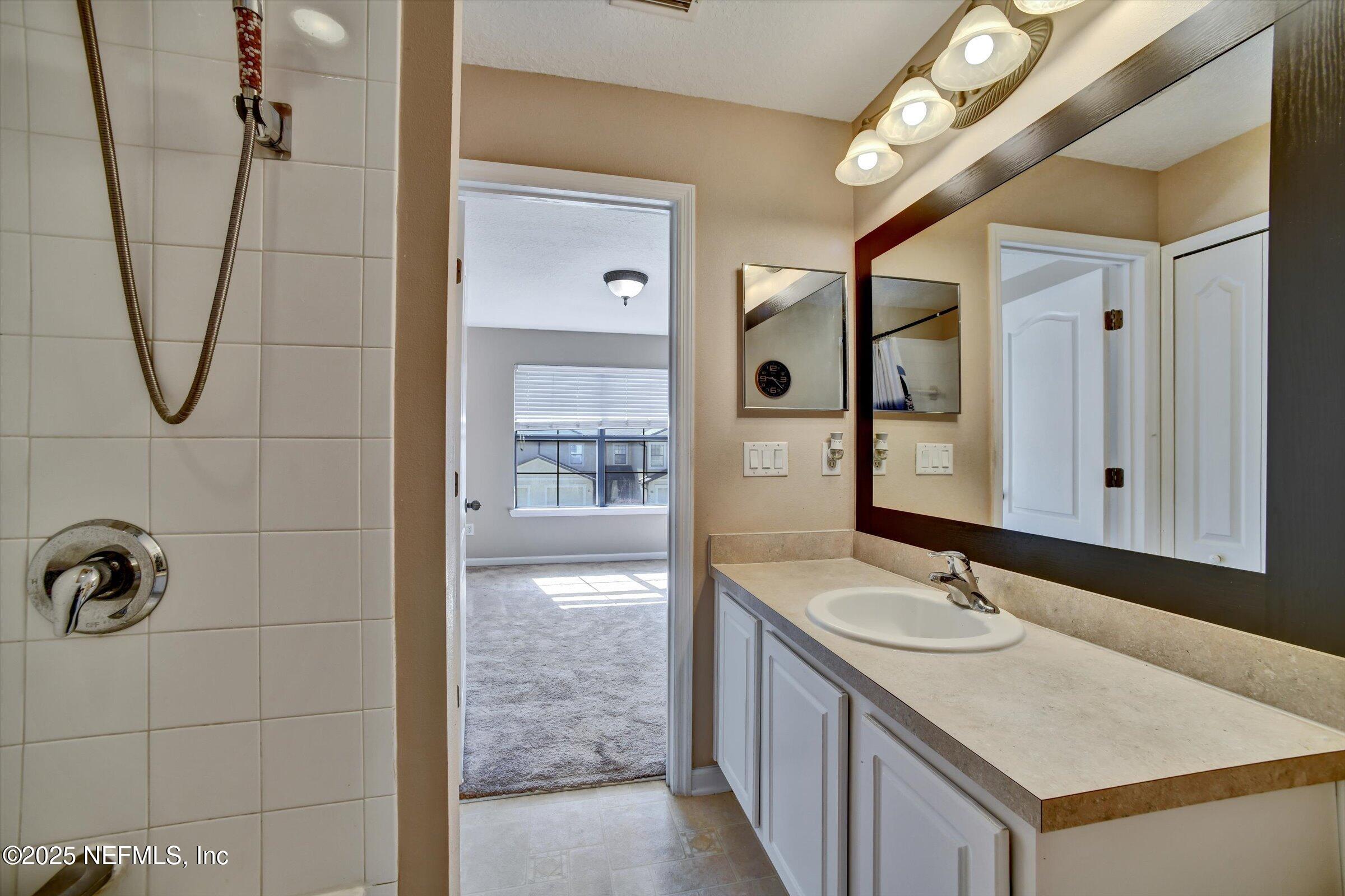 480 Cabernet Place St. Augustine, FL 32084 - Photo 37 of 37 a bathroom with a sink vanity and mirror