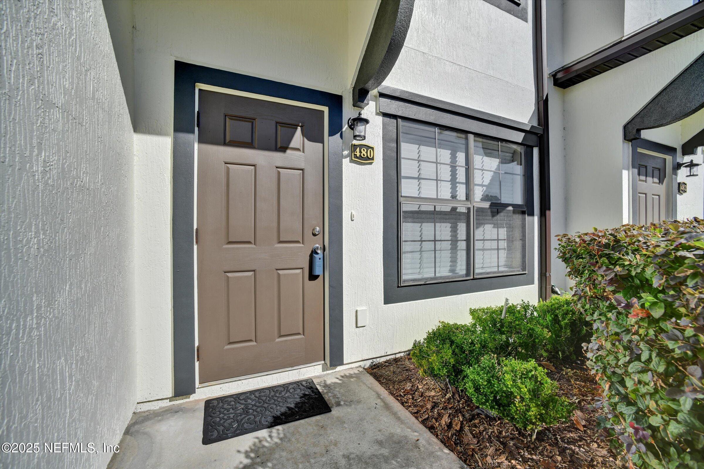 480 Cabernet Place St. Augustine, FL 32084 - Photo 5 of 37 a front view of a house with a glass door