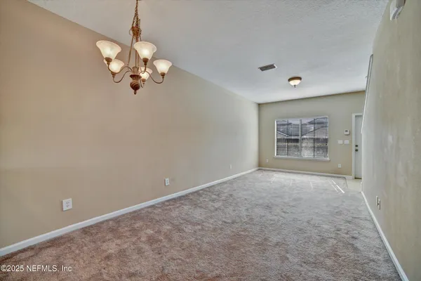 a kitchen with stainless steel appliances granite countertop white cabinets and a stove top oven