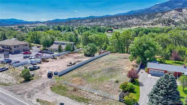 a view of a city with lush green forest