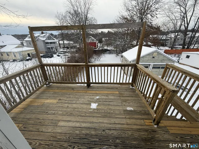 a view of staircase with railing and white walls
