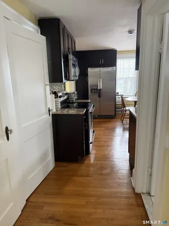 a kitchen with stainless steel appliances granite countertop a refrigerator and a sink