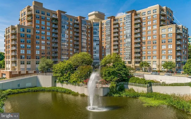 a view of a tall building next to a lake view