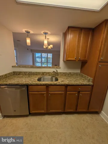 a view of granite countertop kitchen island a stove a sink and dishwasher