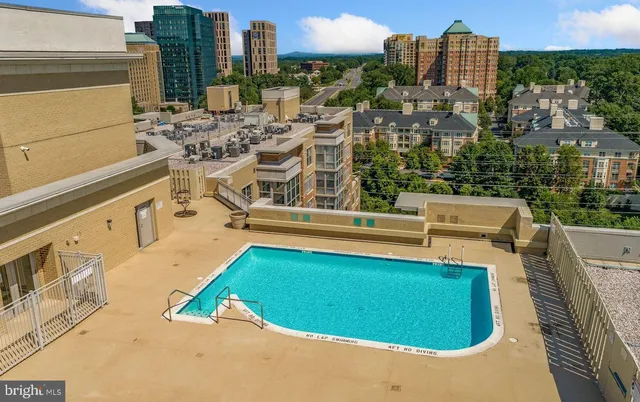 a view of a swimming pool with outdoor seating and city view