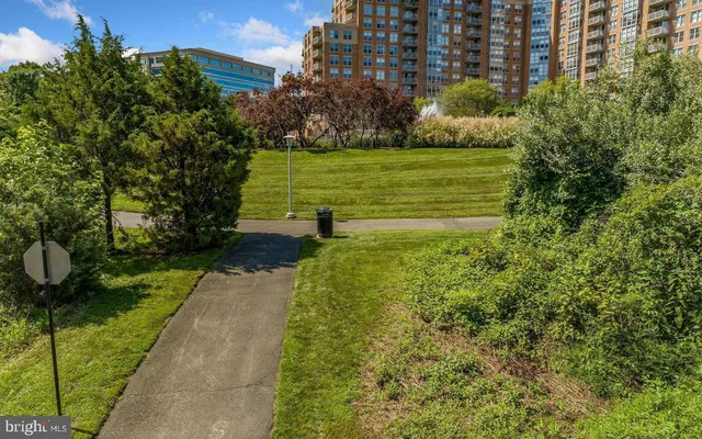 a view of a garden with a building in the background