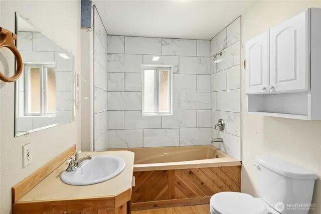 a bathroom with a sink a toilet and a tub