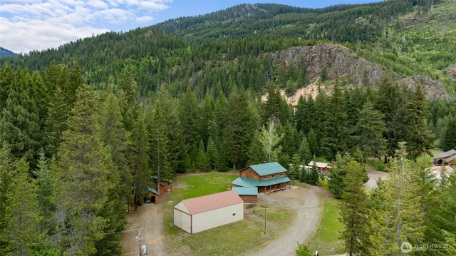 an aerial view of a house with yard