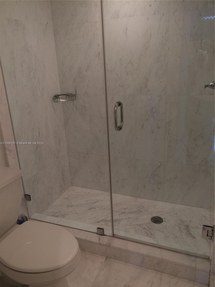 90 Alton Road, Unit 2503 Miami Beach, FL 33139 - Photo 11 of 23 a bathroom with a shower and toilet