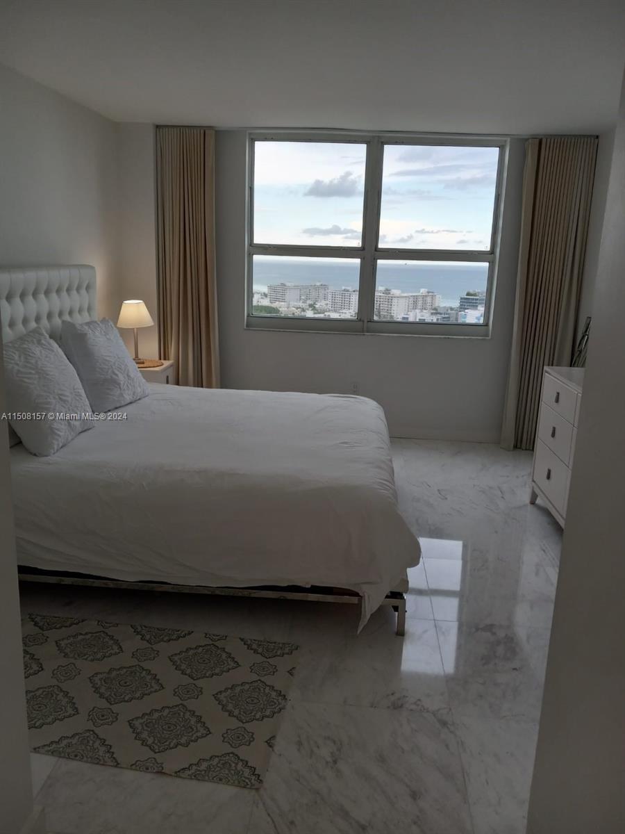 90 Alton Road, Unit 2503 Miami Beach, FL 33139 - Photo 7 of 23 a bedroom with a bed and a window