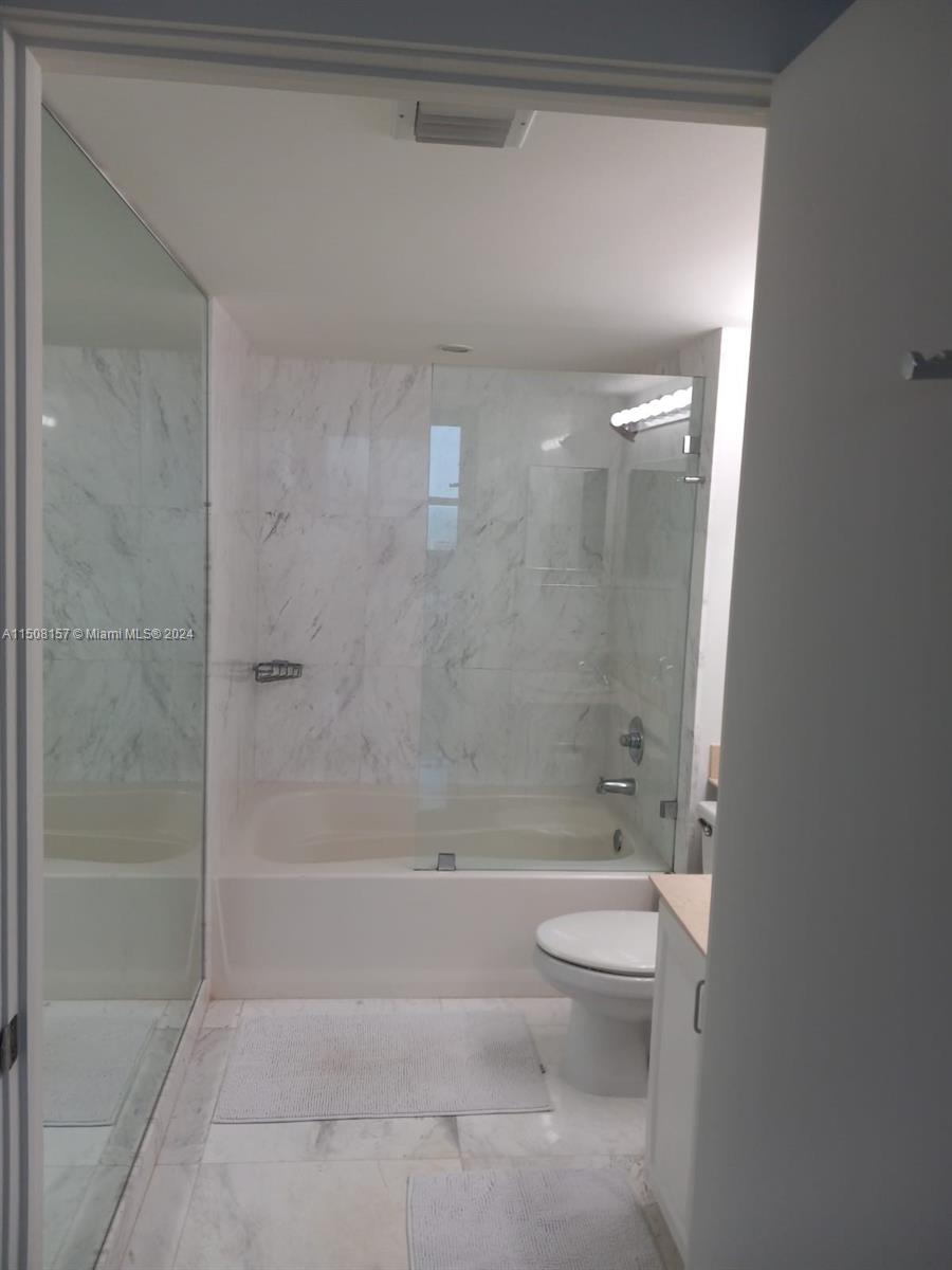 90 Alton Road, Unit 2503 Miami Beach, FL 33139 - Photo 8 of 23 a bathroom with a bathtub and a toilet
