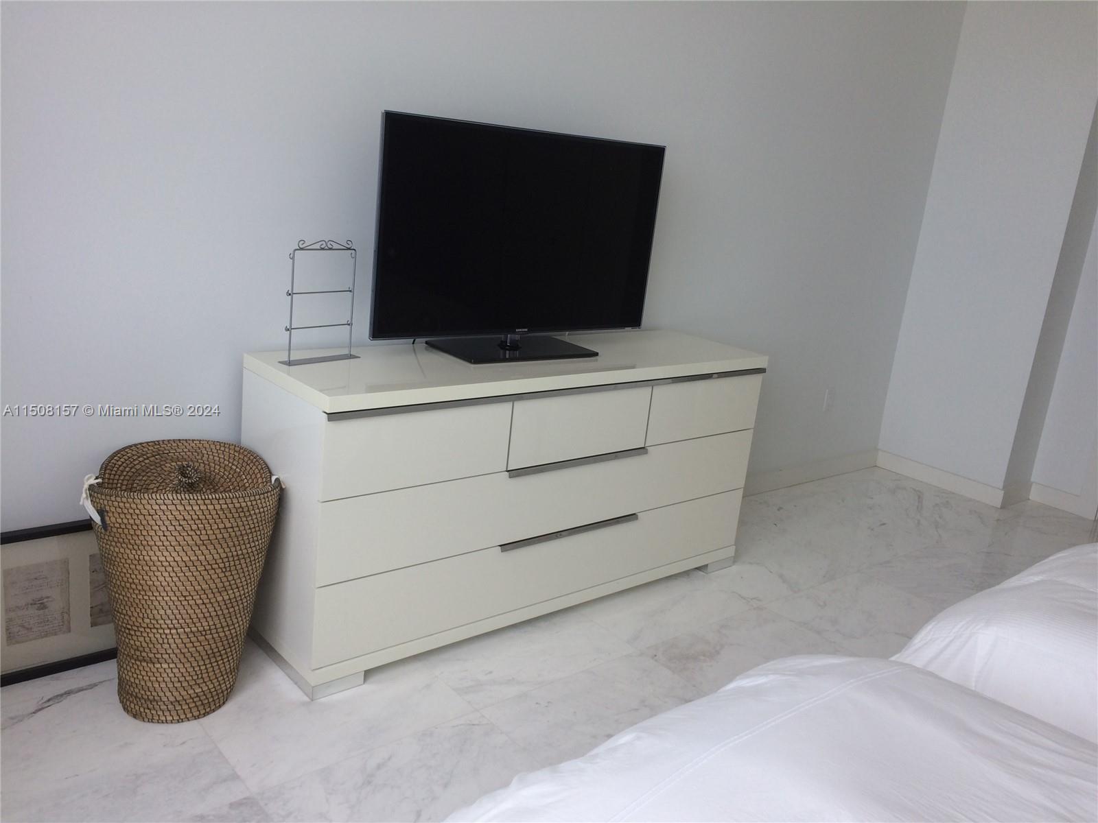 90 Alton Road, Unit 2503 Miami Beach, FL 33139 - Photo 10 of 23 a room with a flat screen tv and washer