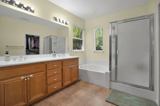 a bathroom with a tub sink and mirror