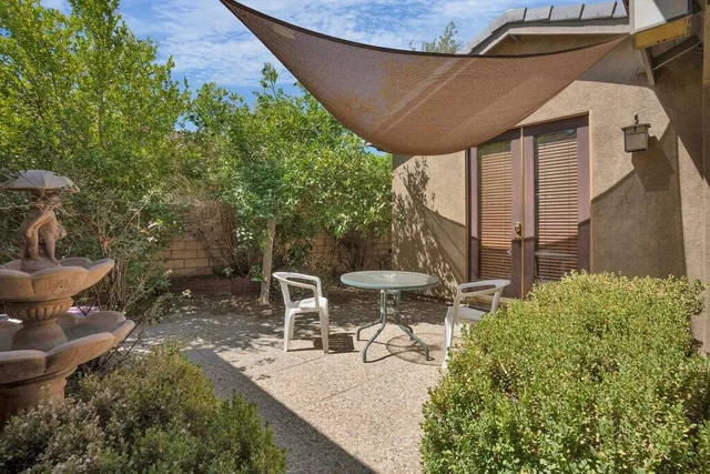 a view of a patio with table and chairs and potted plants