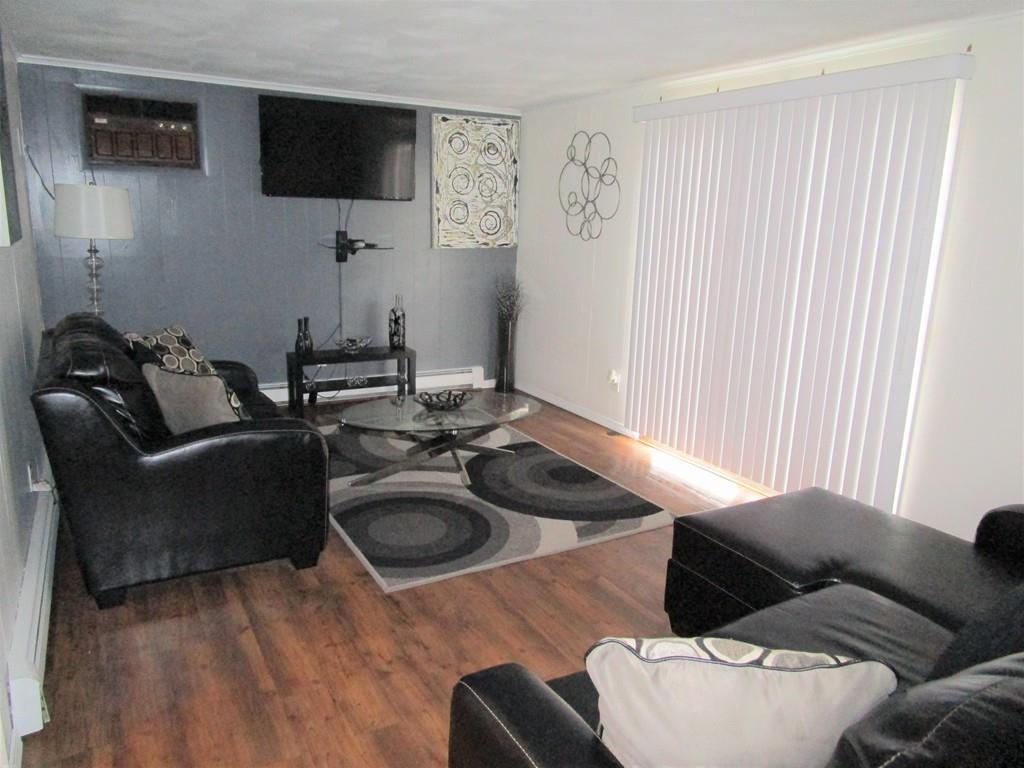 84 Temi Road Brockton, MA 02302 - Photo 15 of 28 a living room with furniture and a flat screen tv