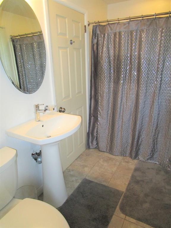 84 Temi Road Brockton, MA 02302 - Photo 19 of 28 a bathroom with a sink a mirror a toilet and vanity