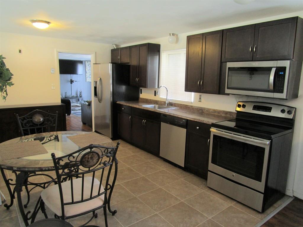 84 Temi Road Brockton, MA 02302 - Photo 2 of 28 a kitchen with a stove a sink and a refrigerator