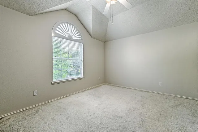 an empty room with a window and a chandelier