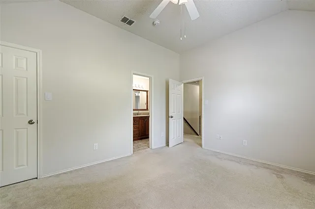 an empty room with closet and windows
