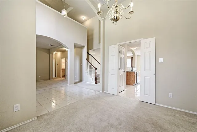 a view of a hallway with chandelier and entryway