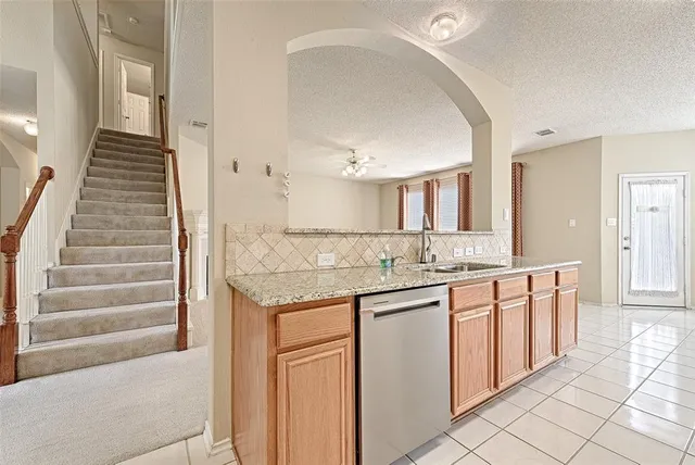 a spacious bathroom with a granite countertop sink and a mirror
