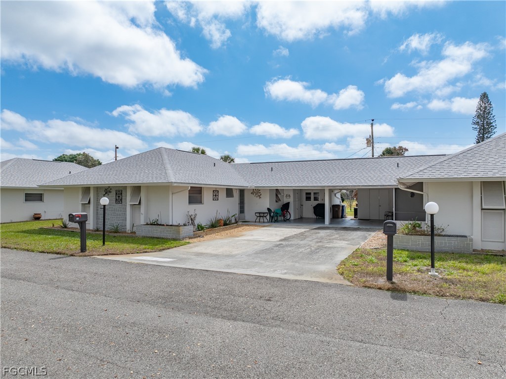 337 Richland Road Lehigh Acres, FL 33936 - Photo 1 of 31 a front view of a house with a yard and garage