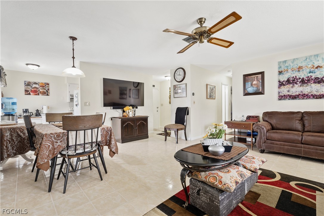 337 Richland Road Lehigh Acres, FL 33936 - Photo 11 of 31 a living room with furniture a rug and a clock