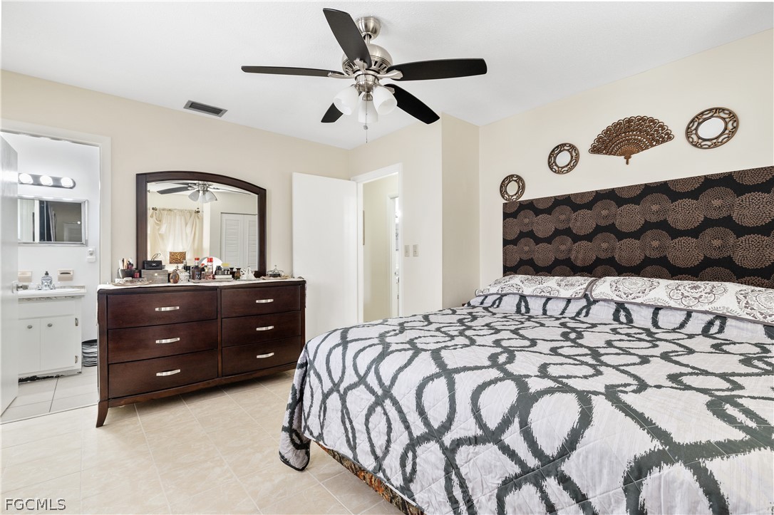 337 Richland Road Lehigh Acres, FL 33936 - Photo 16 of 31 a bedroom with a bed and a mirror on dresser