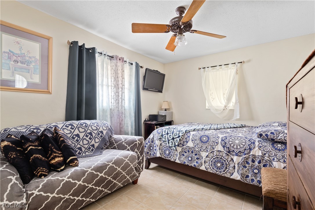 337 Richland Road Lehigh Acres, FL 33936 - Photo 17 of 31 a bedroom with a bed couch and window