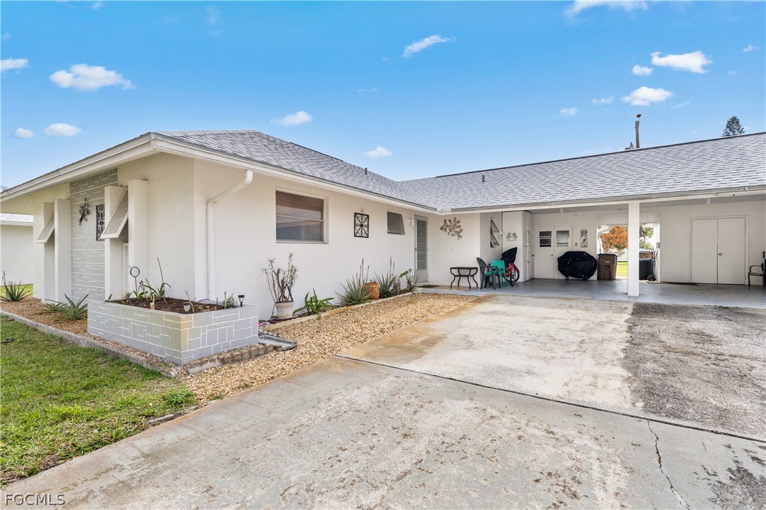 337 Richland Road Lehigh Acres, FL 33936 - Photo 2 of 31 a view of a house with backyard and sitting area