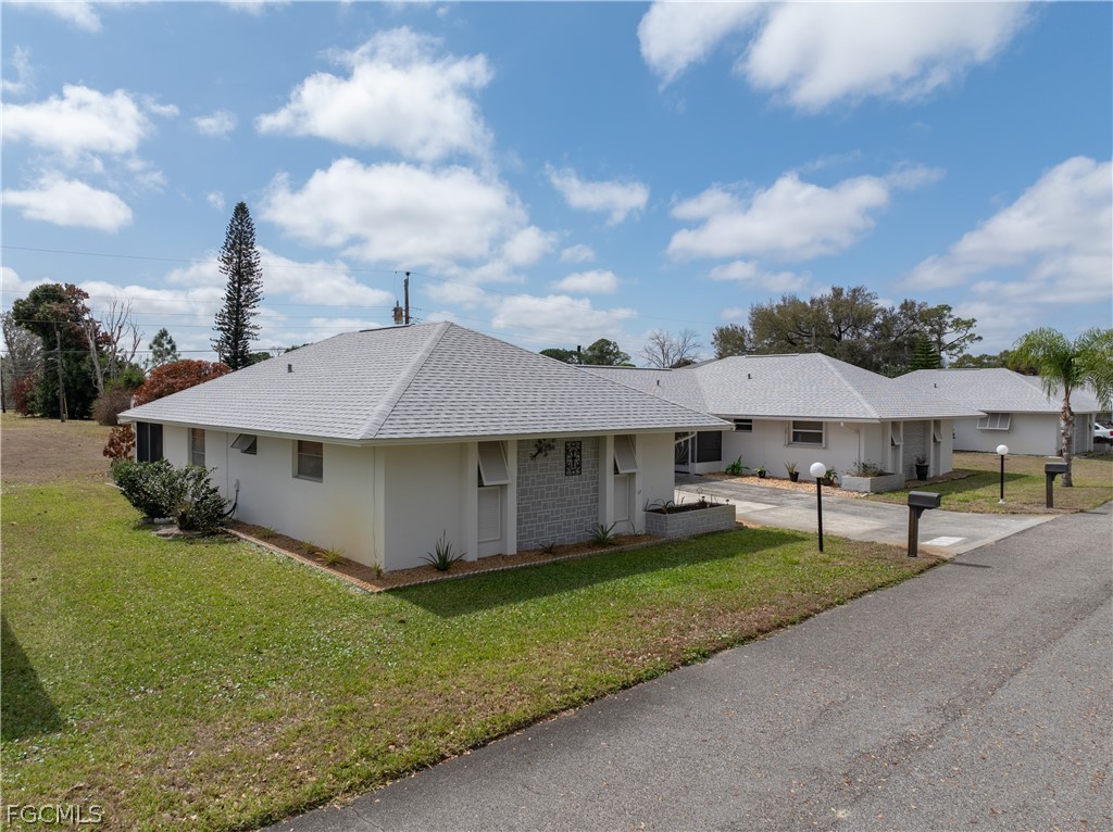 337 Richland Road Lehigh Acres, FL 33936 - Photo 22 of 31 a view of a house with a yard and sitting area