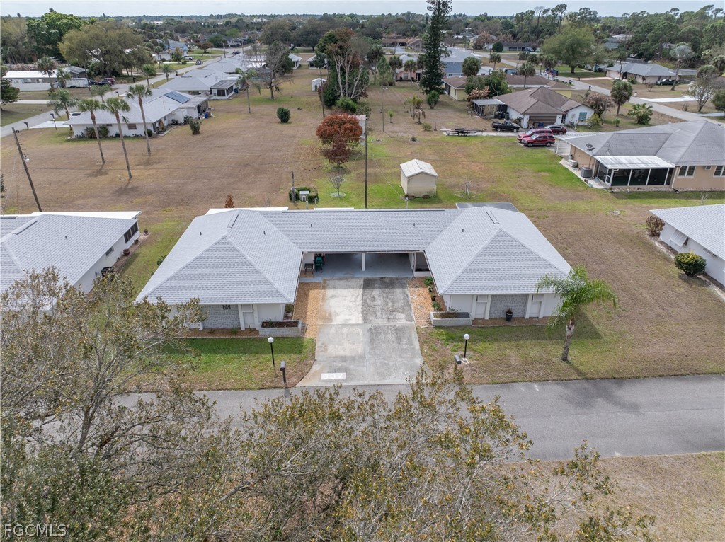 337 Richland Road Lehigh Acres, FL 33936 - Photo 24 of 31 an aerial view of a house with garden space and lake view