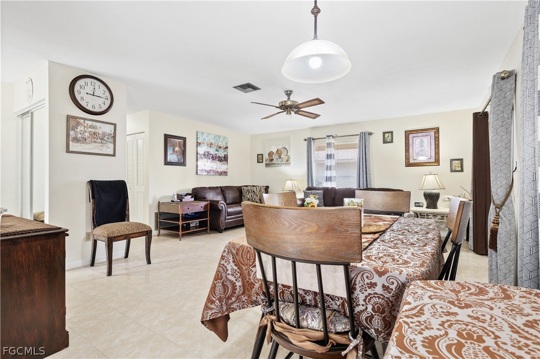 337 Richland Road Lehigh Acres, FL 33936 - Photo 8 of 31 a living room with furniture a clock and a large window