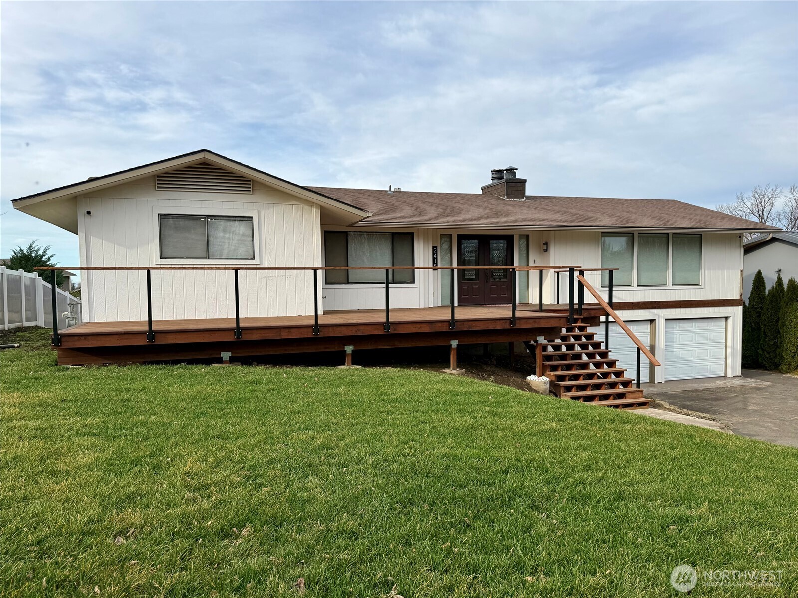 a view of a house with a yard and sitting area
