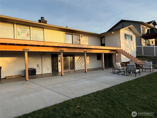 a view of a house with sitting area and a yard