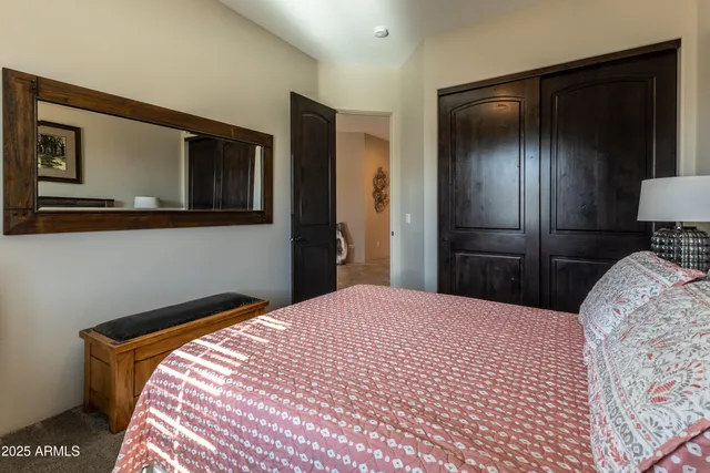 a bedroom with a bed and a large mirror