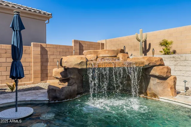 a backyard of a house with table and chairs