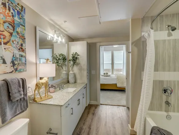 a en suite bathroom with a double vanity sink a mirror and shower