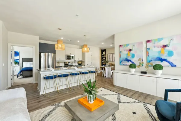 a living room with furniture and kitchen view