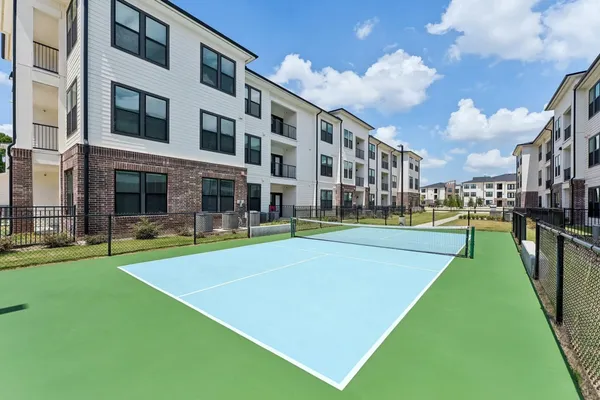 a view of yard with swimming pool and brick wall