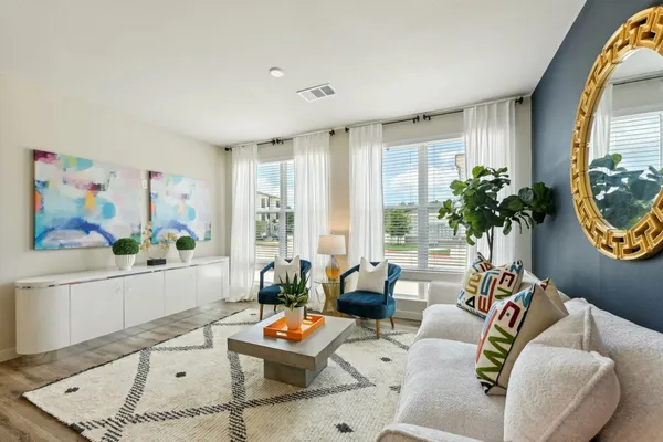 a living room with furniture and a large window