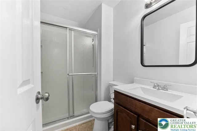 an empty room with a chandelier fan