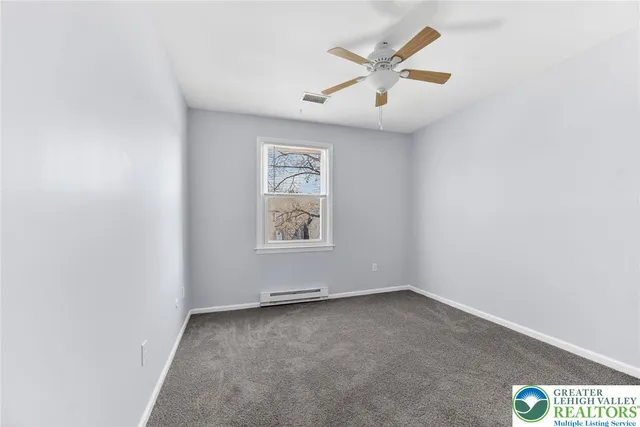 a view of a yard with large trees